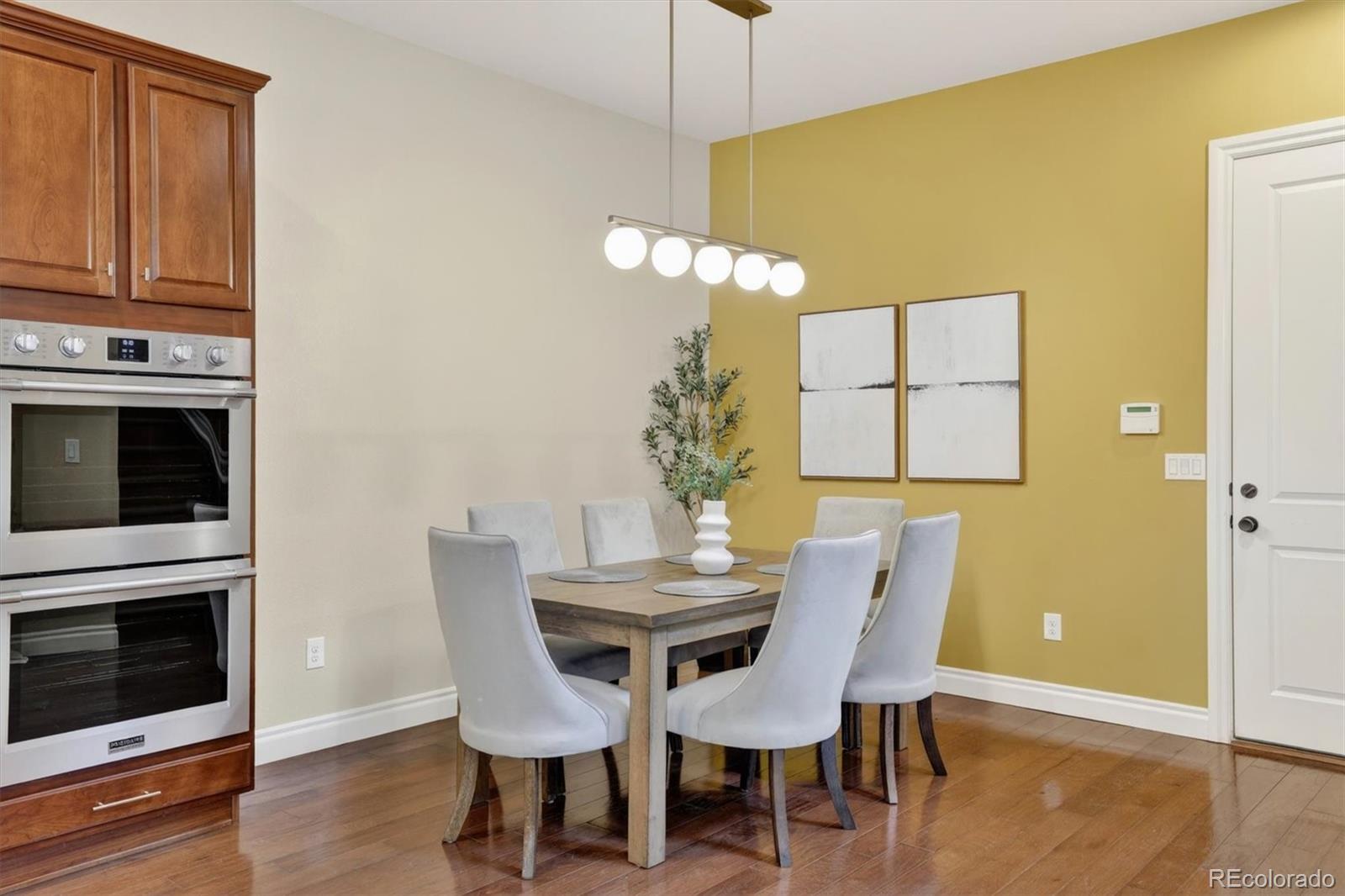 10126 RidgeGate Circle Lone Tree, CO 80124 - Photo 12 of 32 a view of a dining room with furniture and wooden floor