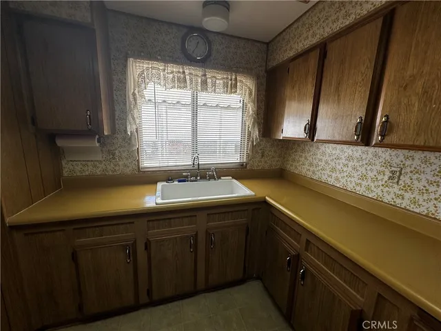 a kitchen with a sink and cabinets