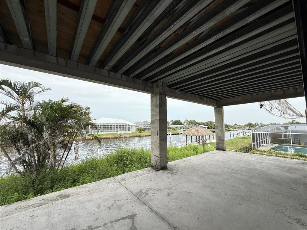 234 Bangsberg Road Southeast Port Charlotte, FL 33952 - Photo 12 of 14 a porch with a floor to ceiling window next to a yard