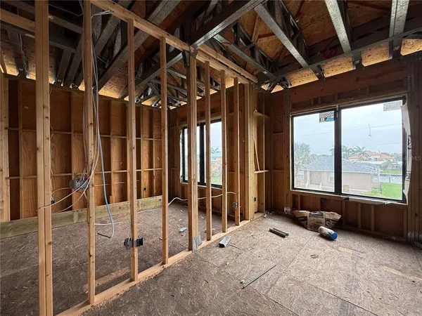 a bed room with a bed and a large window