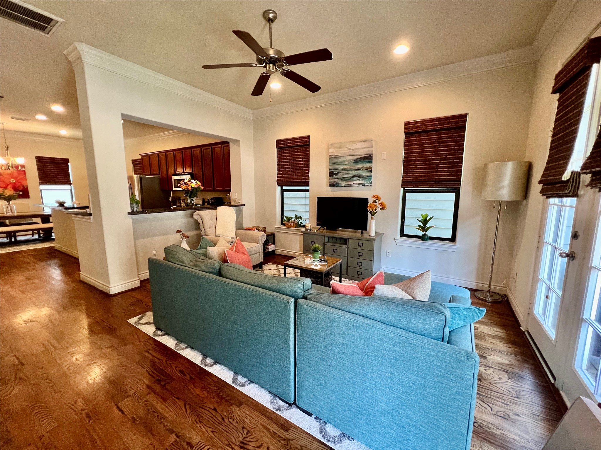 3255 Maxroy Street Houston, TX 77008 - Photo 15 of 26 This inviting living area connects to a dining area and kitchen, creating a spacious feel. Large windows provide ample natural light, and there's a ceiling fan for comfort.