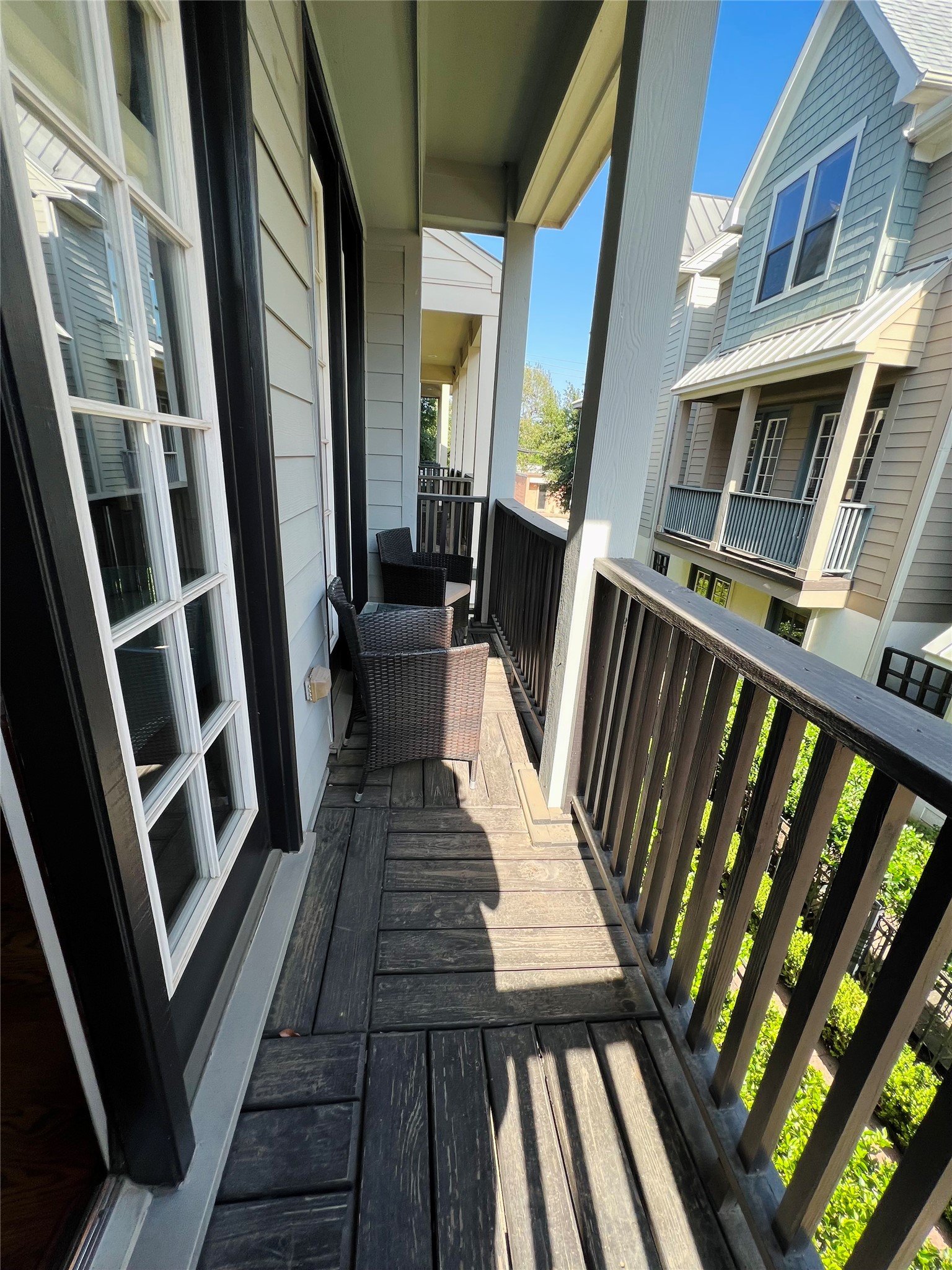3255 Maxroy Street Houston, TX 77008 - Photo 18 of 26 Balcony off living room features classic railing and siding, adding charm to the property.