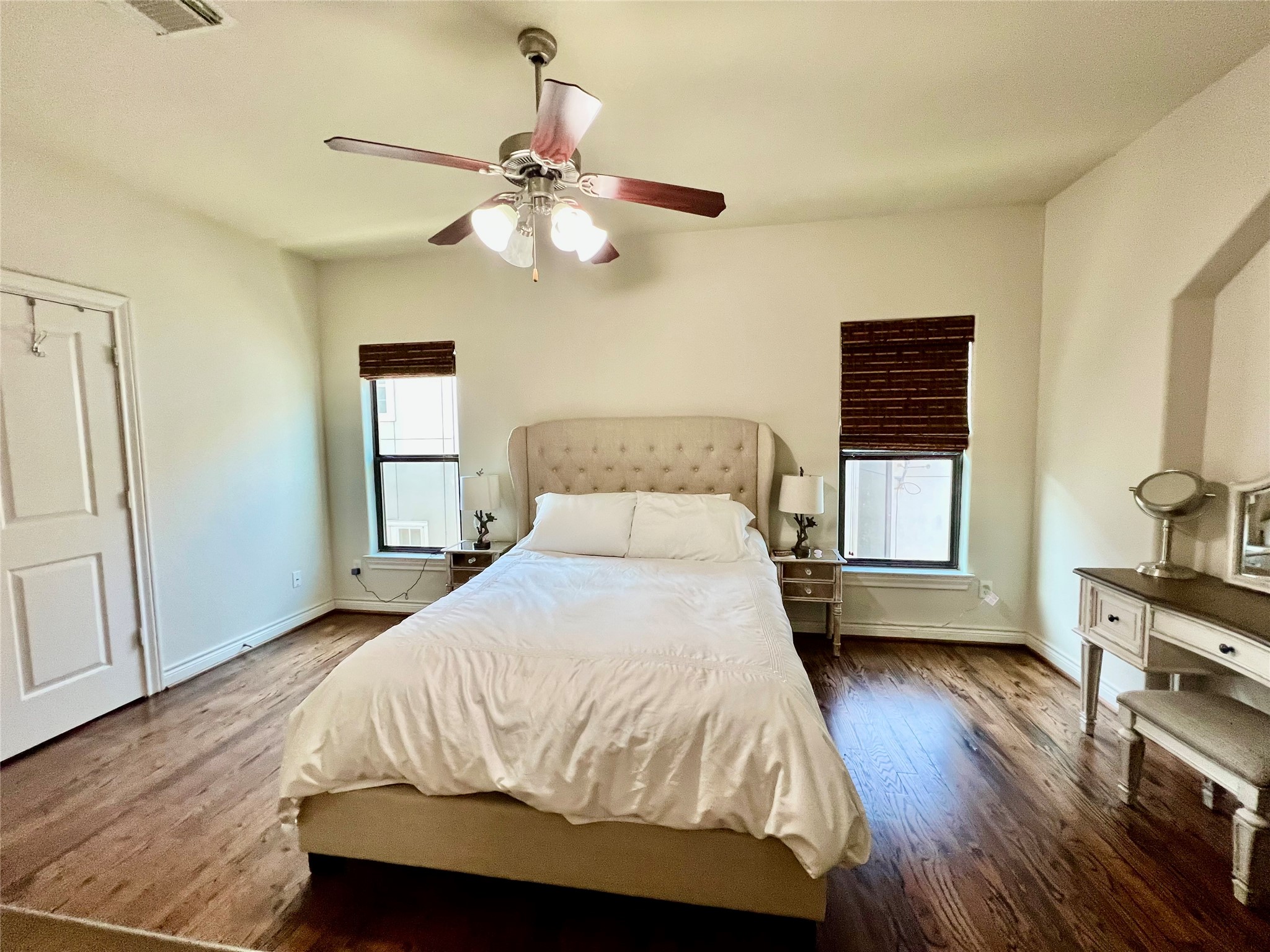 3255 Maxroy Street Houston, TX 77008 - Photo 19 of 26 Master bedroom on third floor features hardwood flooring, a ceiling fan, and ample natural light from two windows with blinds creating a comfortable and inviting space.