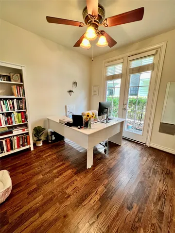 a living room with furniture and a book shelf