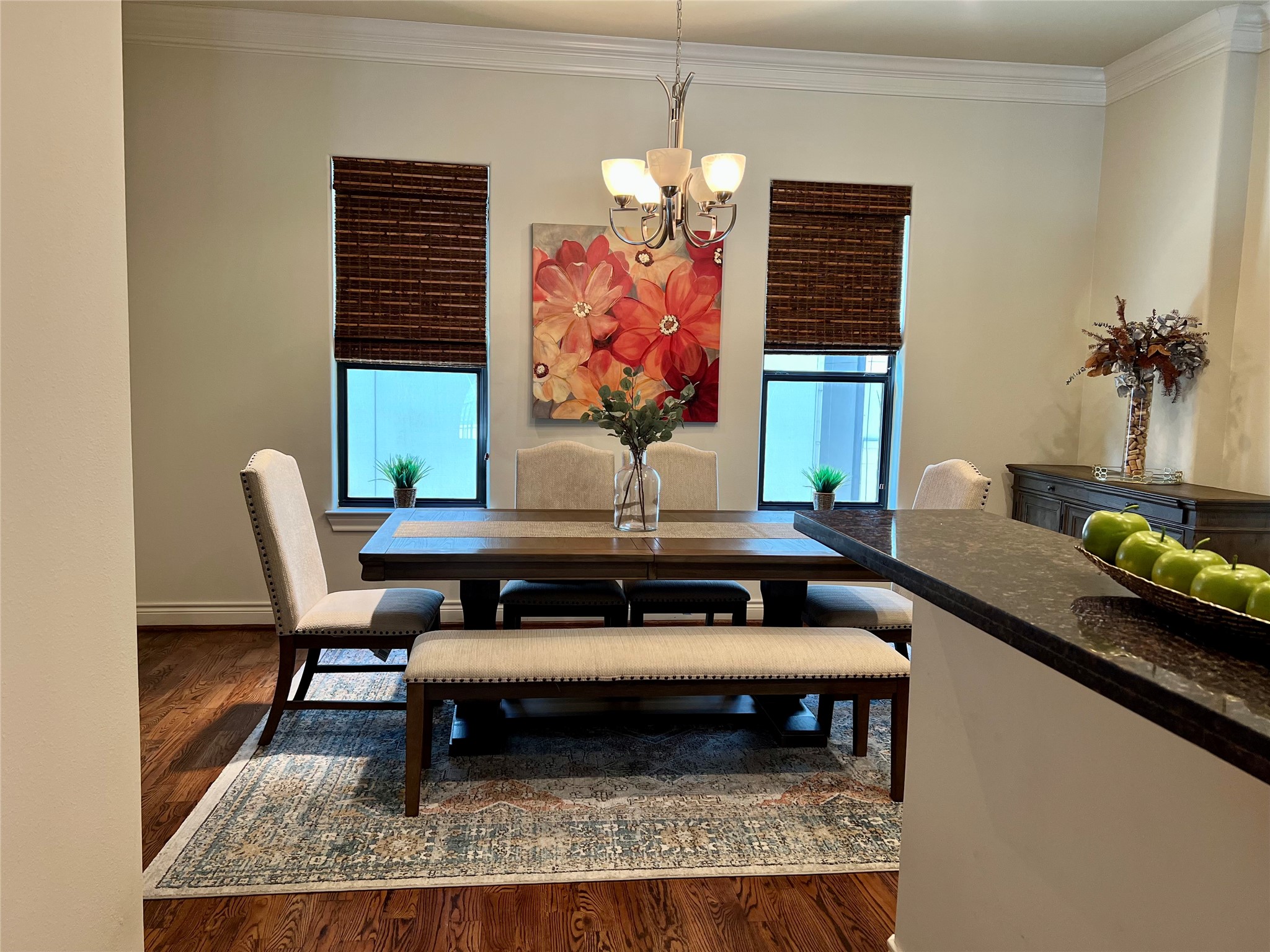 3255 Maxroy Street Houston, TX 77008 - Photo 8 of 26 This dining area features hardwood flooring. The space is accented by two large windows with bamboo blinds, and a chandelier, creating a warm and inviting atmosphere.