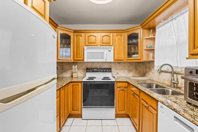 a kitchen with stainless steel appliances granite countertop a sink and a stove