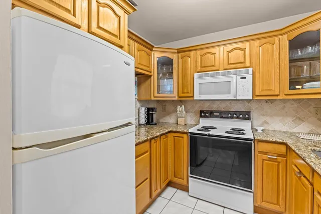 a kitchen with stainless steel appliances granite countertop a stove and a microwave