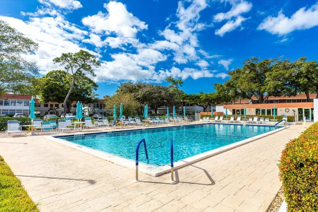 a view of swimming pool with outdoor seating and plants