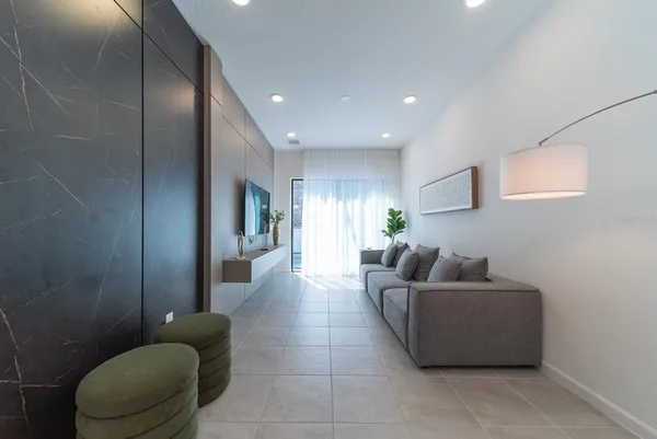 a living room with furniture and a potted plant