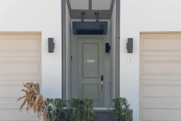 a dining room with furniture and a potted plant