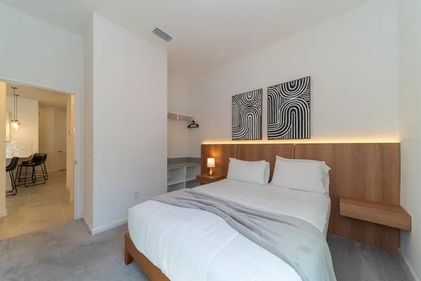 a bedroom with a bed and night stand