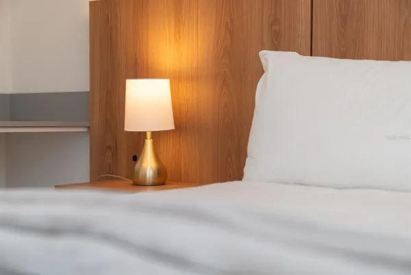 a bedroom with a bed and a window