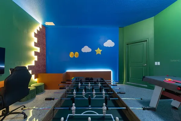 a room with a bed and a painting on the wall