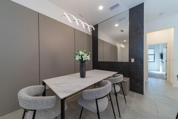 a large kitchen with a table and chairs