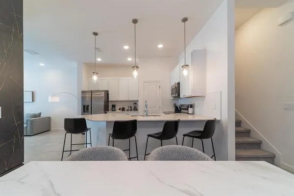 a kitchen with a sink and stove top oven