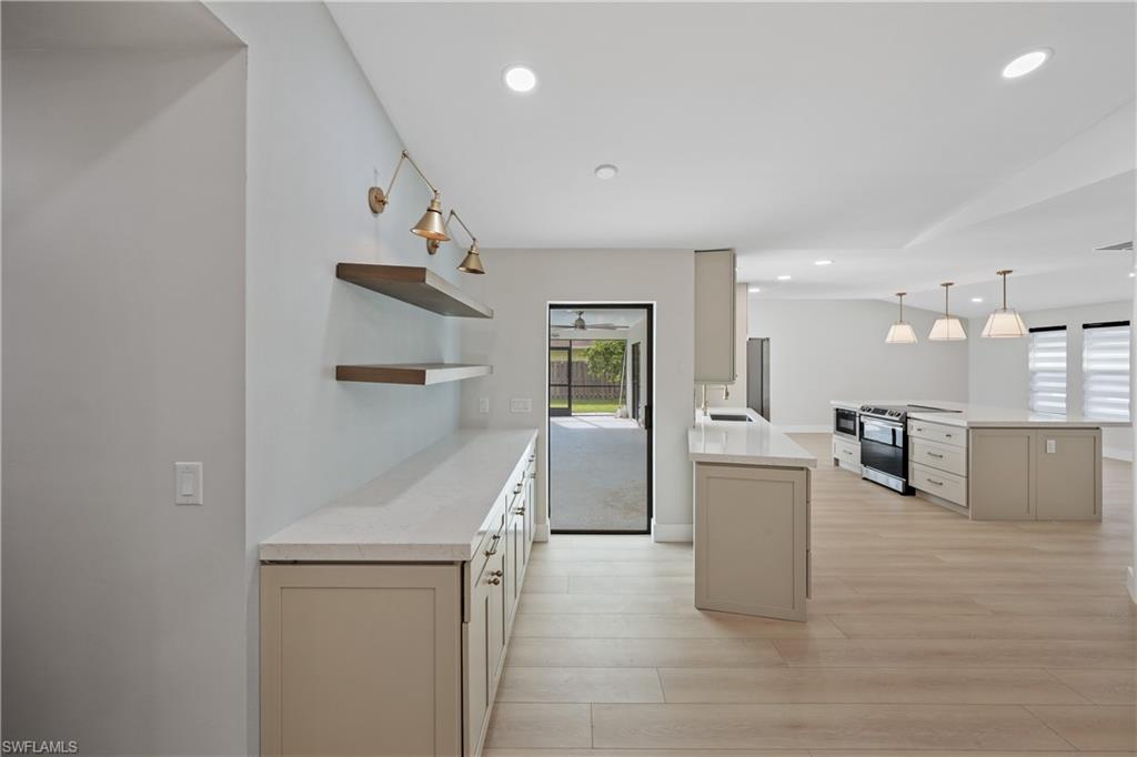 121 Fairway Circle Naples, FL 34110 - Photo 11 of 31 a view of kitchen with furniture and wooden floor