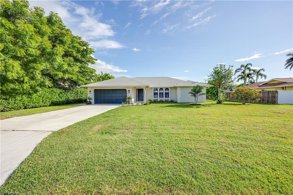 121 Fairway Circle Naples, FL 34110 - Photo 26 of 31 a front view of house with yard and green space