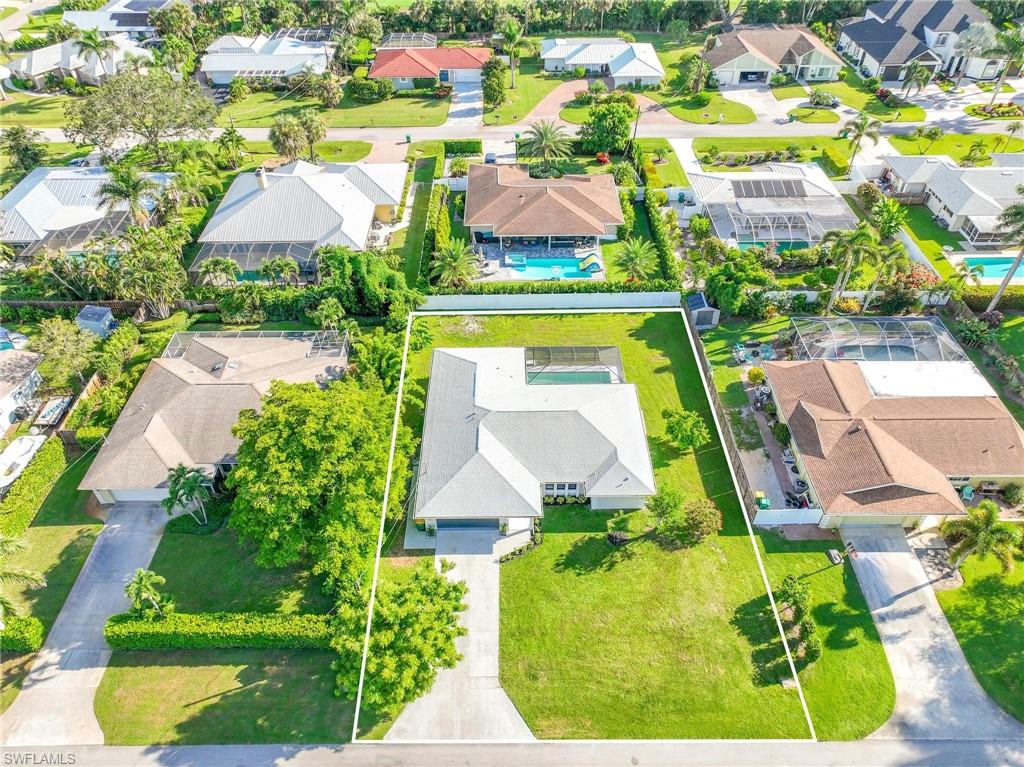 121 Fairway Circle Naples, FL 34110 - Photo 7 of 31 an aerial view of residential houses with outdoor space and street view