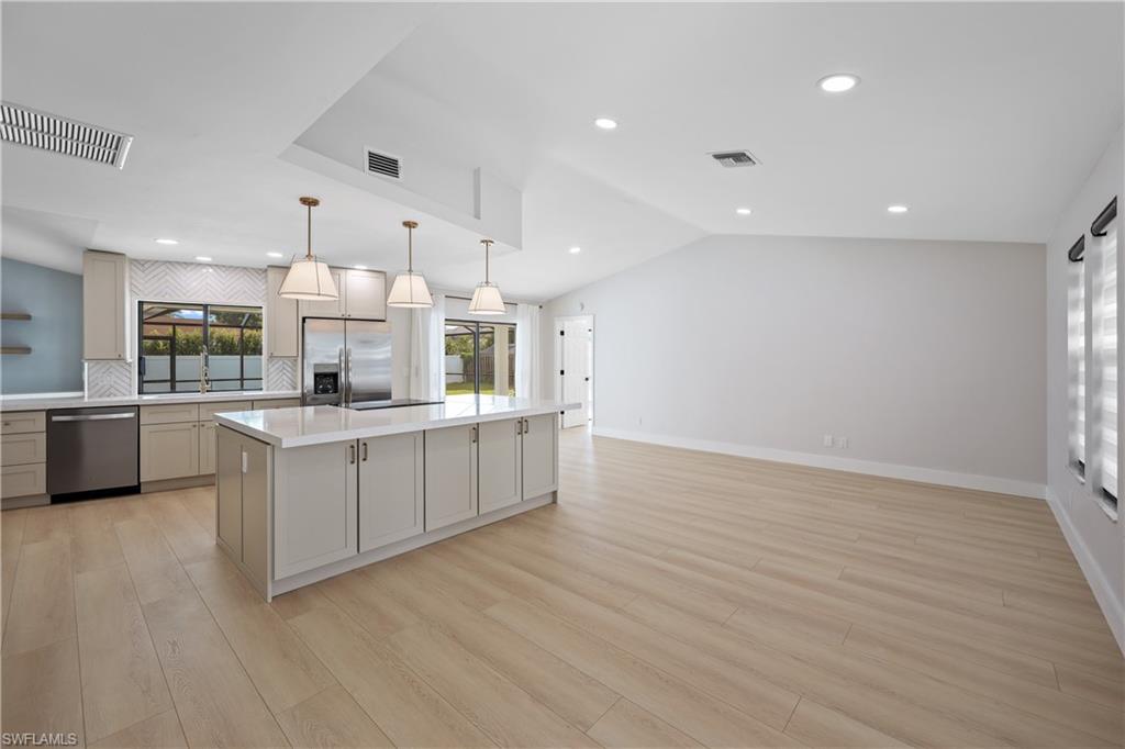 121 Fairway Circle Naples, FL 34110 - Photo 10 of 31 a large kitchen with stainless steel appliances granite countertop a large counter top a sink and a stove