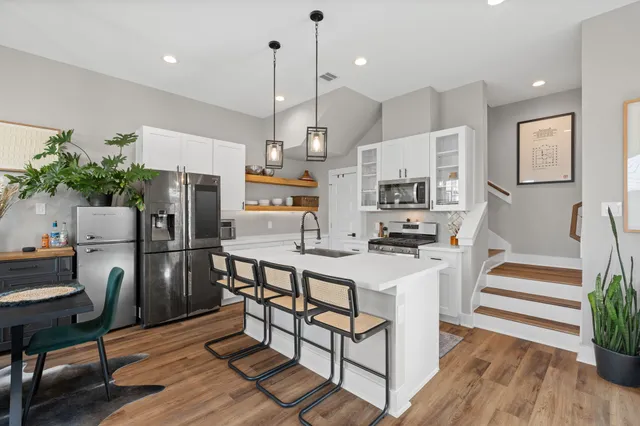 a kitchen with a sink stove and cabinets