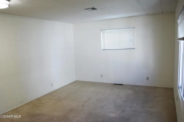 an empty room with a empty space and mirror