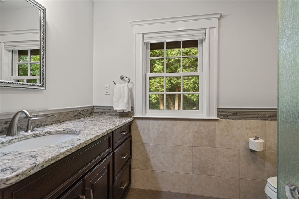 26 Larch Road Newton, MA 02468 - Photo 21 of 34 a bathroom with a granite countertop sink and a window