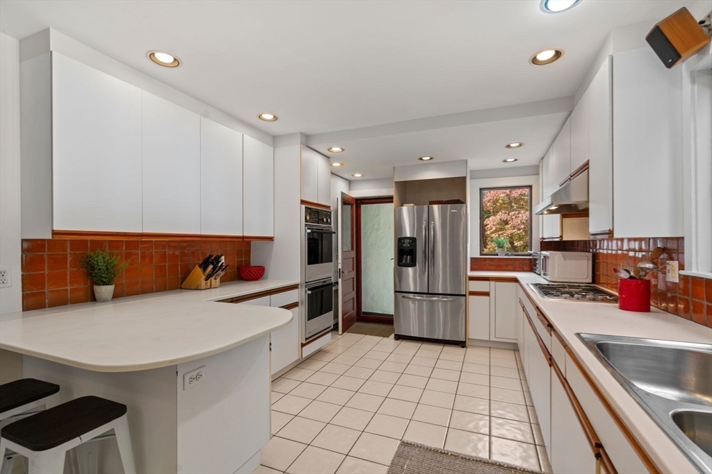 26 Larch Road Newton, MA 02468 - Photo 8 of 34 a kitchen with a sink appliances and cabinets