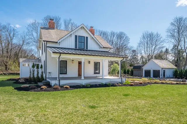 a front view of a house with a yard table and chairs