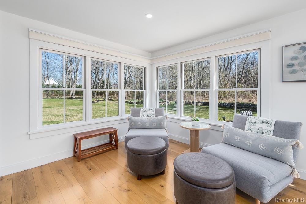 19000 Main Road Mattituck, NY 11952 - Photo 12 of 32 a living room with furniture and a large window