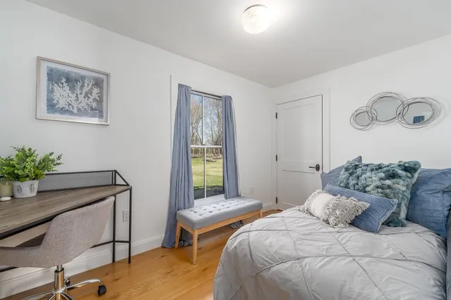 a bedroom with a bed and a potted plant
