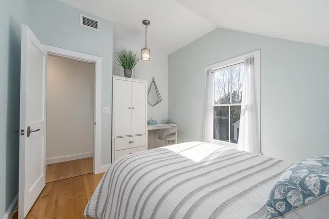 a bedroom with a bed and a window