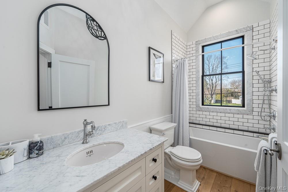 19000 Main Road Mattituck, NY 11952 - Photo 26 of 32 a bathroom with a toilet sink and mirror
