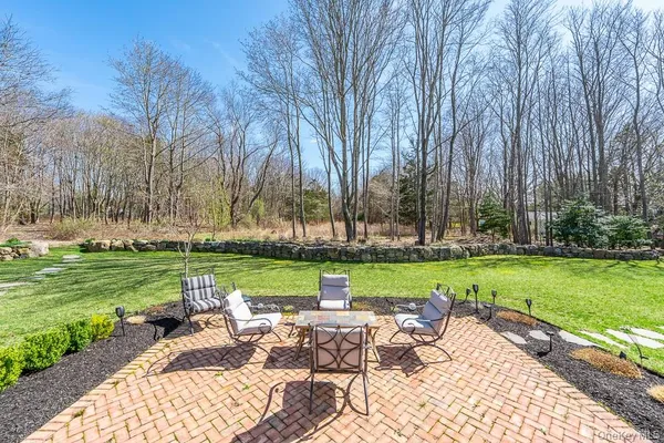 a view of a table and chairs in the garden
