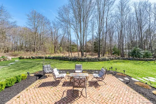 a view of a table and chairs in the garden