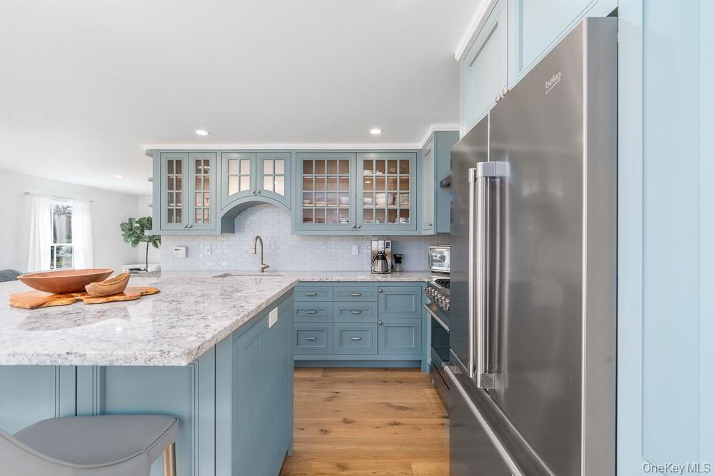 19000 Main Road Mattituck, NY 11952 - Photo 8 of 32 a kitchen with stainless steel appliances granite countertop a refrigerator and a sink