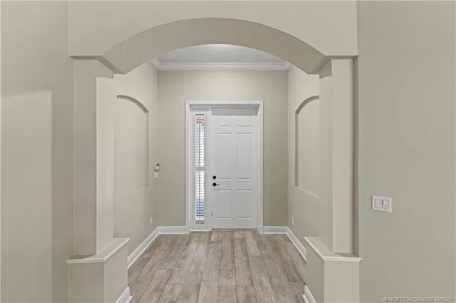 a view of a hallway with wooden floor
