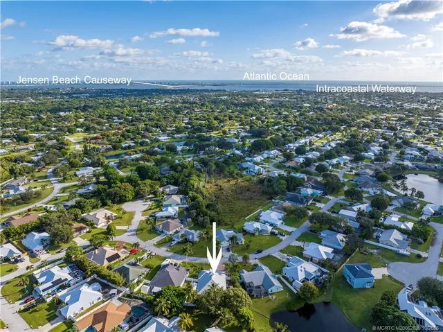 a front view of a house with a garden and yard
