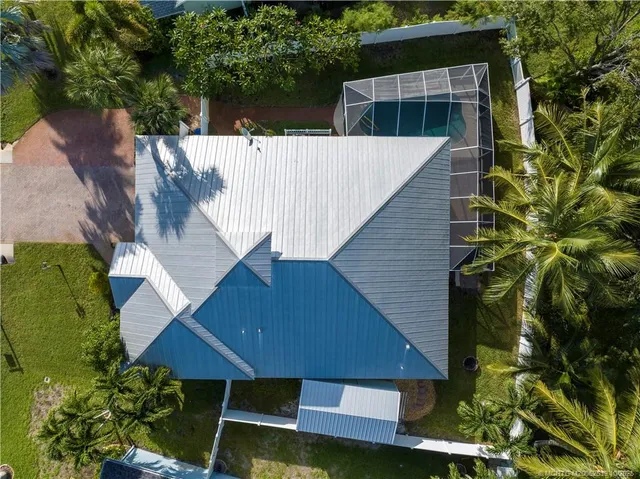 an aerial view of a house with a yard and potted plants