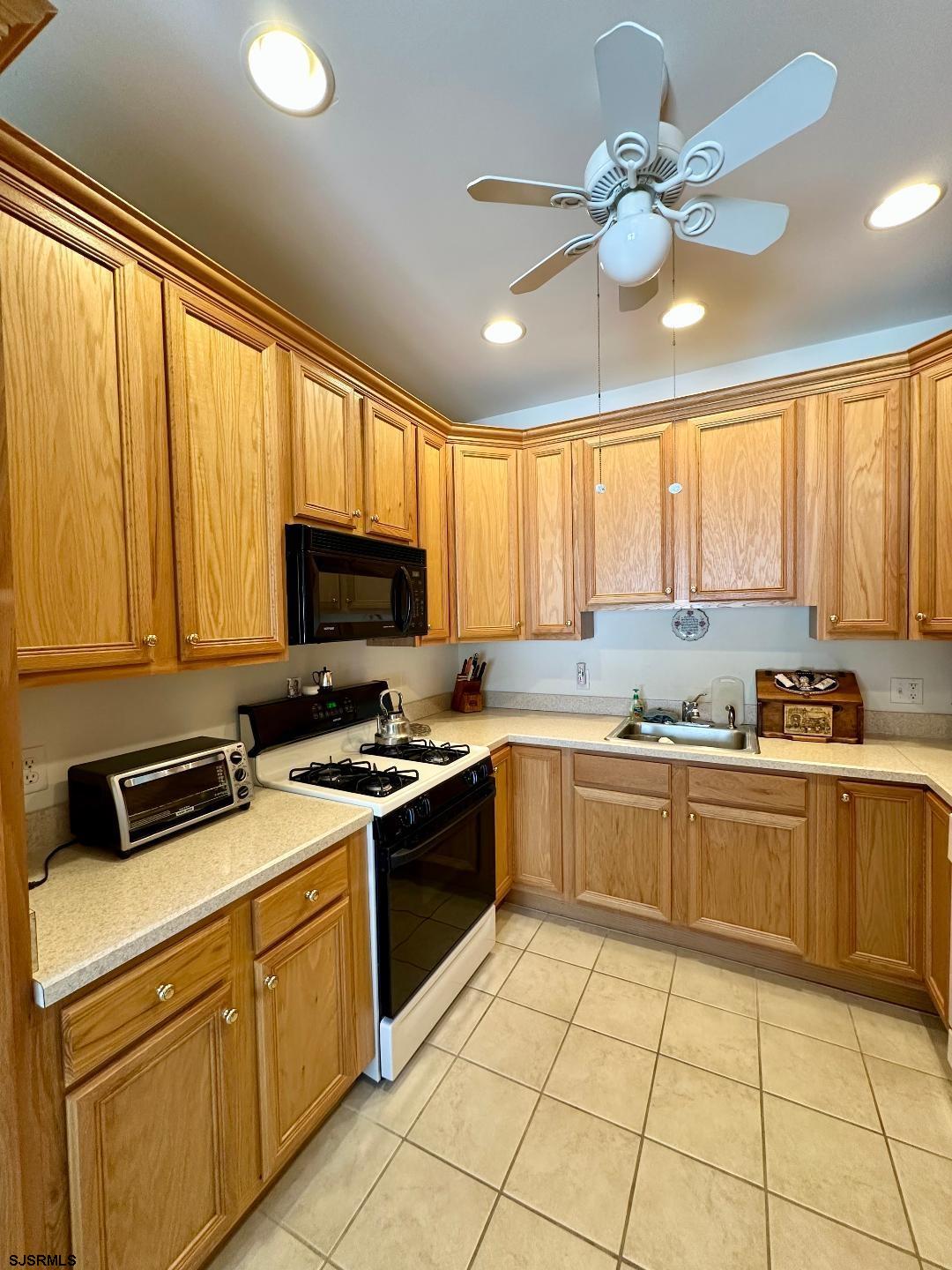 1731 Highway 9, Unit 11 Ocean View, NJ 08230 - Photo 14 of 25 a kitchen with cabinets a sink and appliances