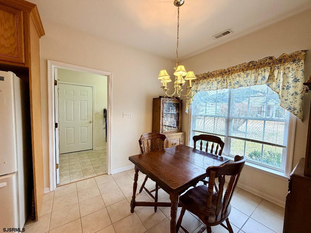1731 Highway 9, Unit 11 Ocean View, NJ 08230 - Photo 7 of 25 a dining room with furniture a chandelier and window