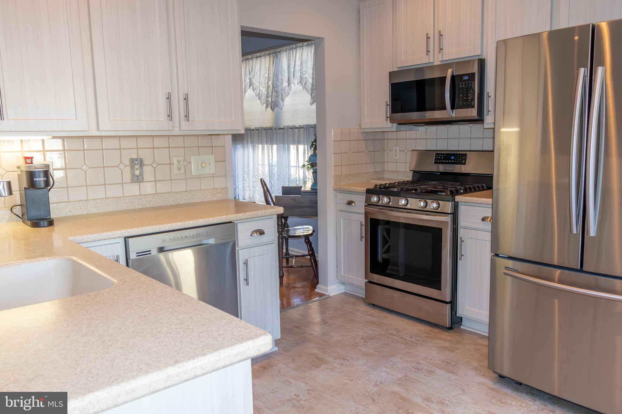 43 Chickadee Way Hamilton, NJ 08690 - Photo 11 of 36 a kitchen with stainless steel appliances a stove a sink and a microwave