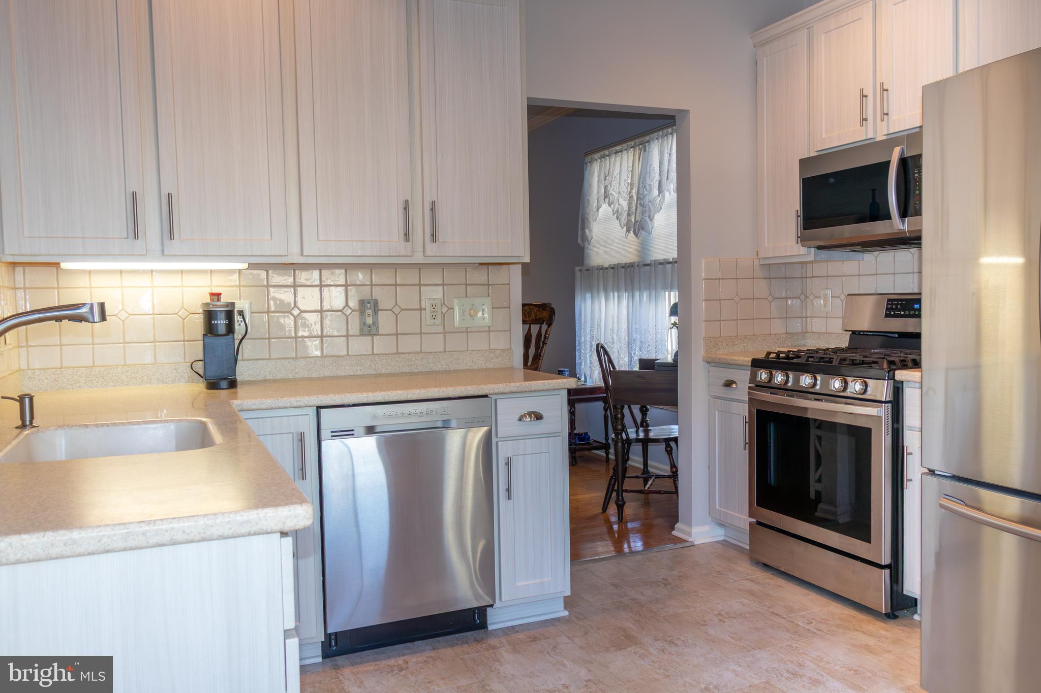 43 Chickadee Way Hamilton, NJ 08690 - Photo 12 of 36 a kitchen with granite countertop a sink stainless steel appliances and cabinets