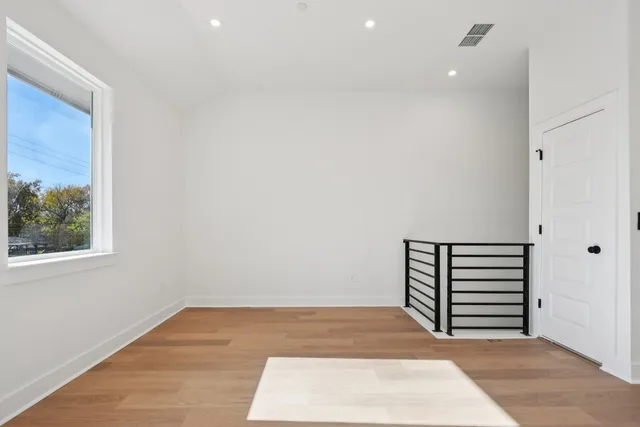 an empty room with wooden floor