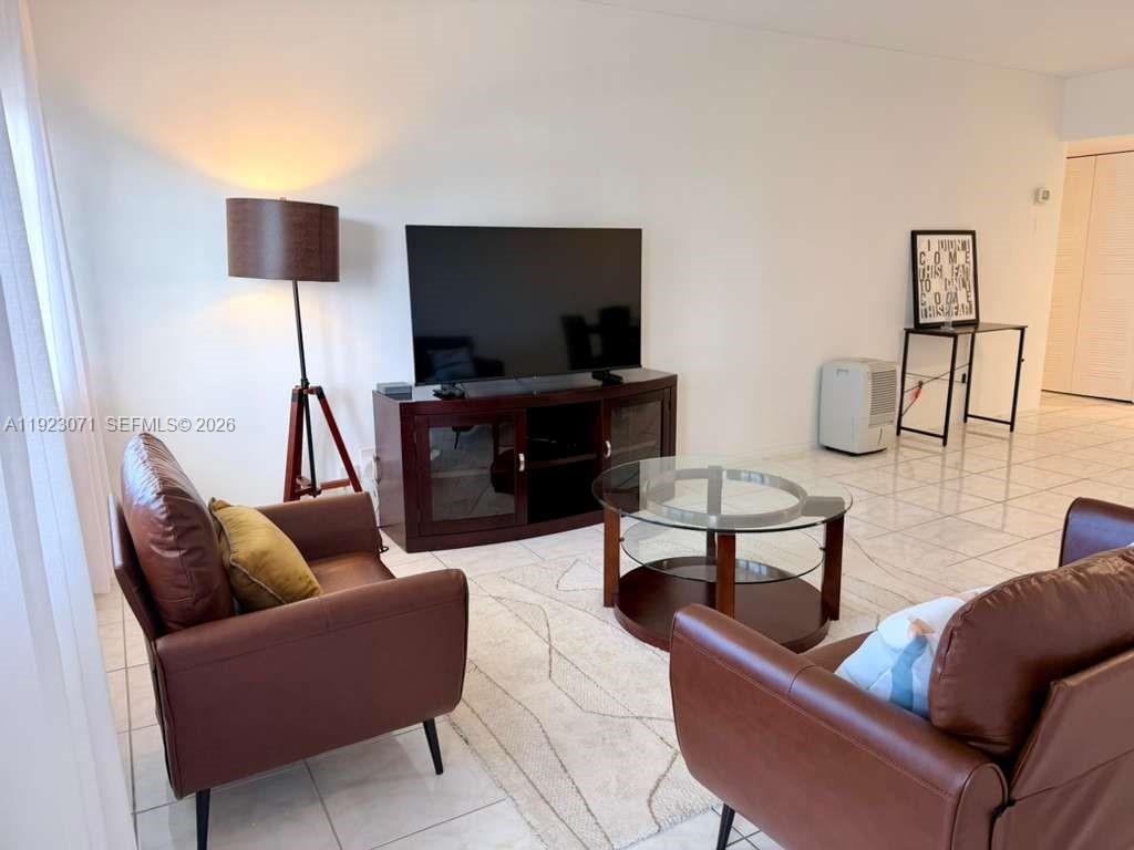 100 Lincoln Road, Unit 541 Miami Beach, FL 33139 - Photo 2 of 17 a living room with furniture and a flat screen tv