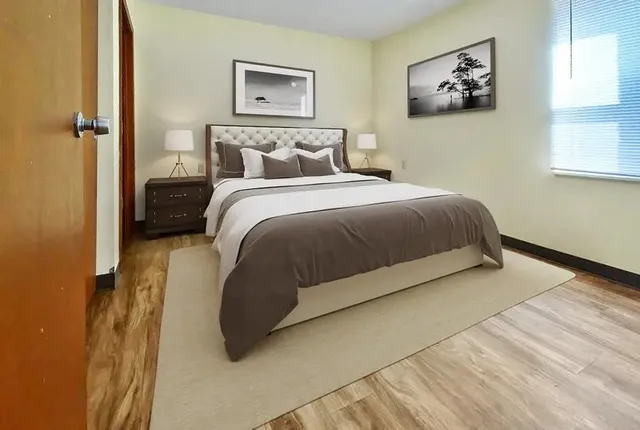 a bedroom with a bed and wall painting