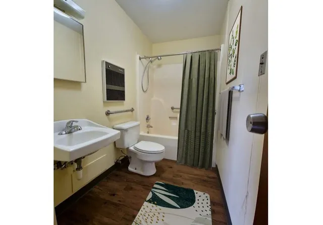 a bathroom with a sink toilet and shower