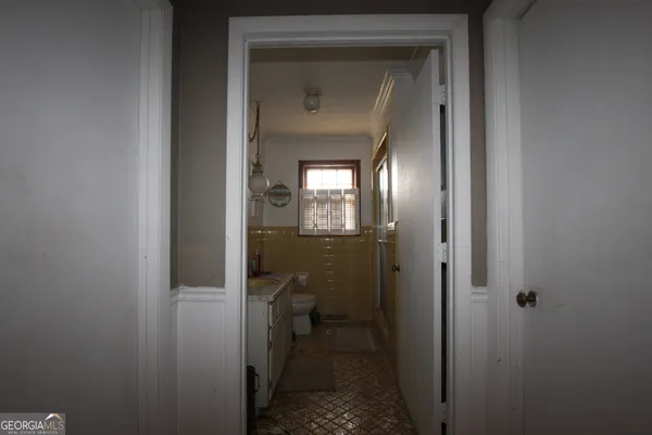 a view of a bathroom from a hallway