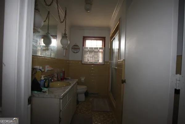 a bathroom with a sink and mirror with toilet