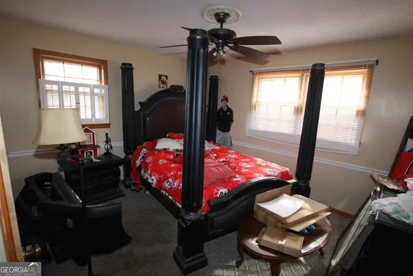a bed room with furniture and a window