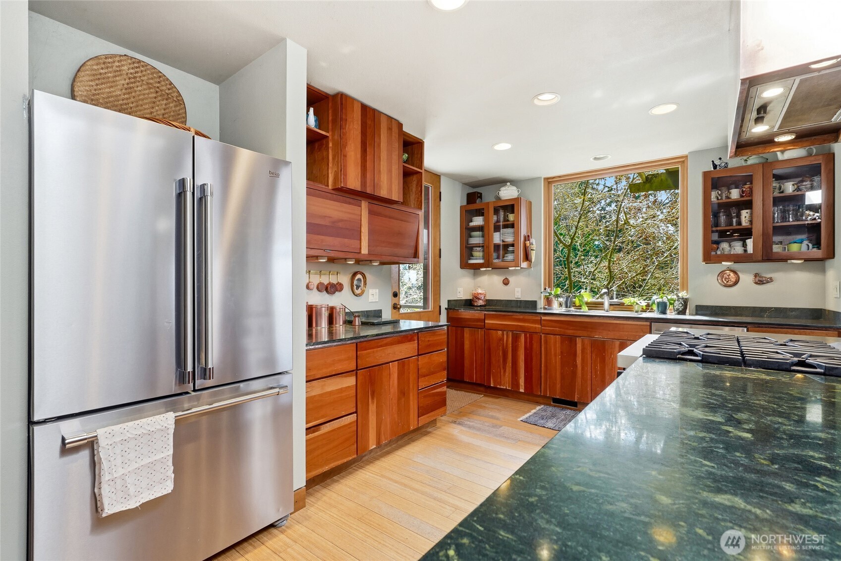 16202 72nd Avenue West Edmonds, WA 98026 - Photo 8 of 23 a kitchen with stainless steel appliances granite countertop a refrigerator a stove and a wooden floors